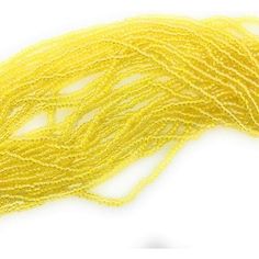 yellow seed beads on a white background