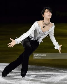 a male figure skating on an ice rink