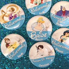 six disney princess buttons are shown on a blue glittered tablecloth with the words bride, bridal, and becc