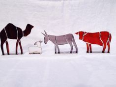 three metal animals are standing in the snow