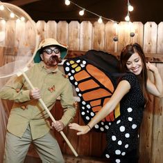 a man and woman dressed in costumes posing for a photo with a butterfly costume on