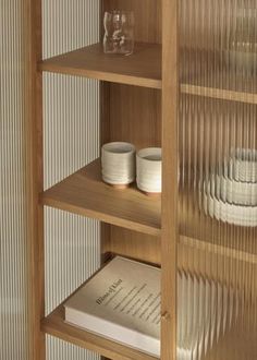 a wooden shelf filled with dishes and glasses