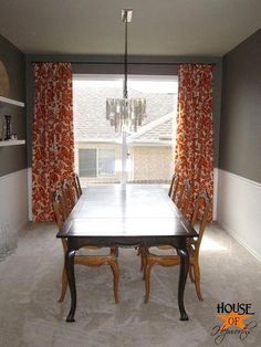 a dining room table and chairs in front of a window