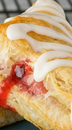 a pastry with white icing and strawberries on it