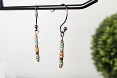 Listing is for 1 pair of dangle earrings.  Adorable and dainty earrings, these Boho earrings are simple and cute. A minimalist's dream! These earrings will be your every day earrings. Simple stick earrings are made with Picasso seed beads and glass beads that hang from unique copper-colored nickel-free ear wires.  Your Bohemian style will really shine through with these cute earrings. Perfect with any outfit - casual, business or special occasion. These dainty earrings are so sweet - they would also make a great gift for her, gift for sister, gift for friend, gift for mom, unique gift for teen, unique birthday gift, unique Christmas gift and a great stocking stuffer.  Want to save on shipping costs? Spend more than $35 and receive FREE shipping! Love these handmade earrings and want to see Minimalist Adjustable Beaded Earrings For Gift, Handmade Adjustable Cartilage Earrings For Everyday, Trendy Beaded Earrings For Everyday, Trendy Nickel-free Beaded Earrings For Everyday, Dainty Beaded Drop Earrings, Dainty Dangle Beaded Earrings, Adjustable Dangle Beaded Earrings For Everyday, Minimalist Beaded Earrings For Everyday, Handmade Minimalist Beaded Dangle Earrings