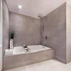 an image of a bathroom setting with bathtub and shower