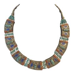 This is part of Chairish’s Fine Jewelry assortment.  This Tibetan Nepalese Tribal Necklace with Inlay Turquoise, Lapis and Carnelian Beads is even prettier in person. If you want to make a stunning statement, this vintage necklace with 100% hand-crafted workmanship and beautiful inlay compressed Turquoise and Coral beads does the job. It’s truly a one of a kind, show-stopper.  Condition: Excellent vintage condition with no missing stones; please see pics for details. Measures: Length of the necklace : 228mm ( 19″ ) Width of the Pendant : 25mm ( 1″ ) No marks Bohemian Blue Multi-stone Turquoise Necklace, Blue Multi-stone Bohemian Turquoise Necklace, Handmade Turquoise Ceremonial Necklaces, Traditional Blue Inlay Necklaces, Traditional Blue Necklaces With Inlay, Traditional Blue Necklace With Inlay, Multicolor Adjustable Traditional Turquoise Necklace, Traditional Adjustable Turquoise Necklace, Traditional Adjustable Turquoise Necklace With Natural Stones