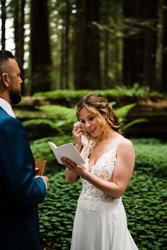 the bride and groom are getting married in the woods