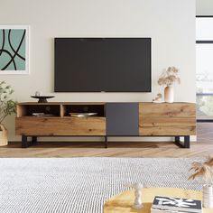 a living room with a large flat screen tv mounted on the wall and wooden furniture