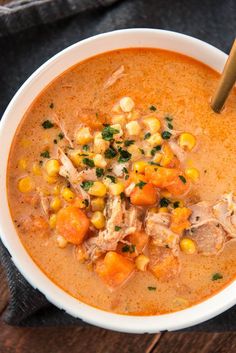 a white bowl filled with soup on top of a wooden table