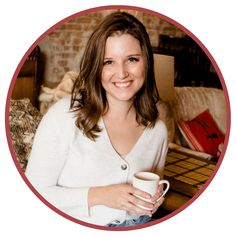 a woman is holding a coffee cup and smiling