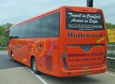 an orange bus is parked on the side of the road