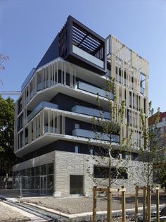 an apartment building with balconies on the top floor