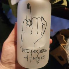 a person holding up a plastic bottle with the word future mrs hogs written on it