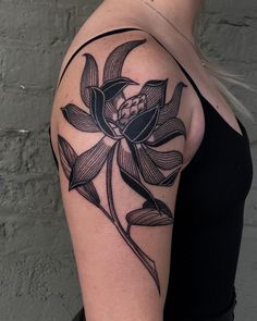 a woman's arm with a flower tattoo on the left side of her arm