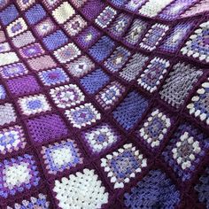 a crocheted blanket with squares and hearts on it