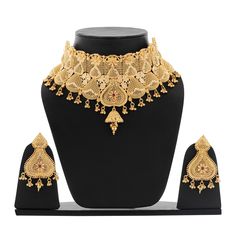 Elevate your bridal look with this exquisite choker necklace set. Crafted with intricate gold-plated detailing and adorned with sparkling kundan stones, this set exudes timeless elegance. The matching jhumka earrings complement the necklace perfectly, creating a stunning ensemble for your special day. This set is perfect for gift ,weddings, receptions, and other formal occasions. It can also be styled with traditional attire for a festive look. Features: Material: High-quality gold-plated metal, Cheap Gold Sets For Navratri, Extravagant Wedding Dresses, Indian Choker, Necklace Set With Earrings, Extravagant Wedding, Weddings Receptions, Bridal Choker, Choker Necklace Set, Traditional Attire