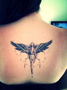 a woman's back with a tattoo on her shoulder and an angel above it