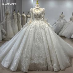 a white ball gown with sequins on the shoulders and neckline is displayed in a store