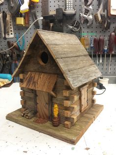 a bird house made out of wood in a workshop