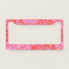 a pink and red license plate frame on a white surface with an image of flowers