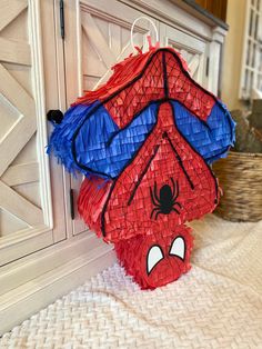 a spiderman pinata hanging on the wall