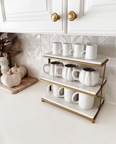 a kitchen counter with coffee mugs on it