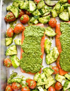 salmon and cucumber salad with pesto dressing in a baking pan ready to be eaten