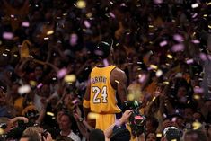 the basketball player is surrounded by fans and confetti