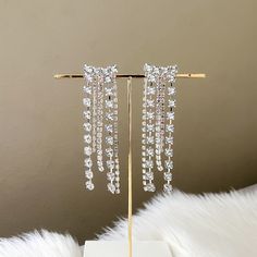 Our Rana Rhinestone Duster Earrings are statement making earrings that sparkle and shine with cascading layers of rhinestones falling in a rainbow arch. Perfect for when you want to add that final touch that will catch the spotlight, these glamorous earrings are perfect for New Year’s Eve parties or dancing through the night! 925 Silver Post - can be a bit flexible This is a special occasion item = FINAL SALE Glamorous Rhinestone Dangle Chandelier Earrings, Crystal Chandelier Earrings With Rhinestone Fringe, Glamorous Crystal Chandelier Earrings With Rhinestones, Rhinestone Fringe Drop Earrings For Wedding, Crystal Earrings With Rhinestone Fringe For Wedding, Evening Crystal Earrings With Rhinestone Fringe, Crystal Earrings With Rhinestone Fringe, Glamorous Crystal Earrings With Rhinestones, Wedding Rhinestone Fringe Drop Earrings