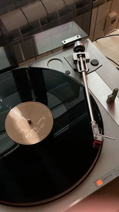 an old record player sitting on top of a table