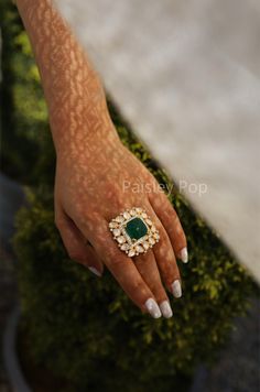 The gold plated polki ring is a combination of heritage and contemporary forms handcrafted by the artisans of India with carved emerald to celebrate perfect armor between old and modern concepts. The Indian polki ring is a beautiful work of art with a royal touch to adorn your hand and be a companion on your special days. Pair this stone ring, which is a replica of Sabyasachi jewelry with your Indian or contemporary ensemble, and complete the look. Closure - Adjustable Style Tip - This delicate Indian Emerald Ring, Emerald Ring Indian, Big Stone Ring Design, Emerald Jewelry Necklace Indian, Indian Rings Traditional, Kundan Rings Royals, Bridal Rings Indian, Indian Rings Gold, Big Rings Indian