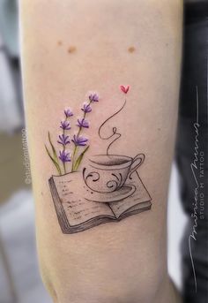 a tattoo on the leg of a woman with a cup of coffee and lavenders