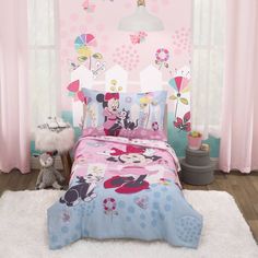 a child's bedroom with pink walls and mickey mouse bedding, white fluffy rugs