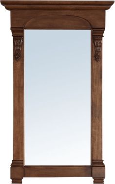 a wooden mirror frame with carvings on the top and bottom edge, along with a white background