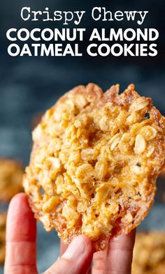 a hand holding up a coconut almond oatmeal cookie