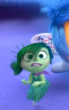 a cartoon character with green hair and blue eyes is standing next to an orange bird