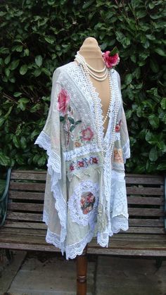 a woman's dress is displayed on a wooden bench