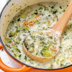 a pot filled with broccoli soup and a wooden spoon