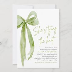 an elegant green bow is on the front of this modern, watercolor wedding card