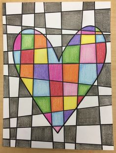 a heart made out of colored squares on a piece of paper with the word love written in it