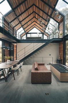 a living room filled with furniture under a wooden roof