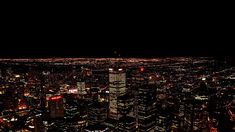 an aerial view of the city lights at night from high up in the skyscrapers