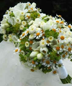 the bride's bouquet is made up of white and orange flowers