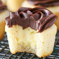 a piece of cake with chocolate frosting sitting on a cooling rack