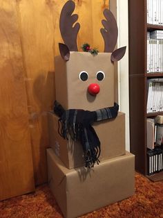 a cardboard box with a reindeer head on top and scarf around it's neck