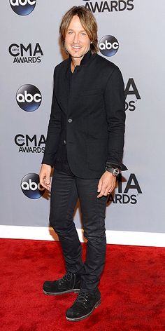 an image of a man in black on the red carpet at cma music awards