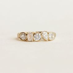 a gold ring with three diamonds on it