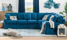 a living room with blue couches and pillows