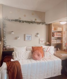 a white bed sitting in a bedroom next to a window